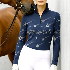 Woman wearing RIDER ATELIER shooting star quarter-zip top with a chestnut horse
