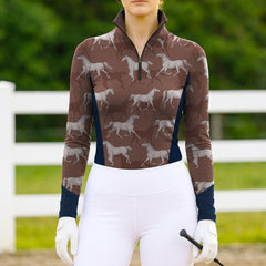 Woman wearing RIDER ATELIER sketch galloping horse quarter-zip top at the outdoor pasture
