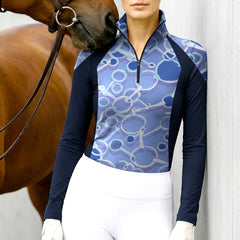 Woman wearing RIDER ATELIER snaffle bit color block quarter-zip top with a chestnut horse