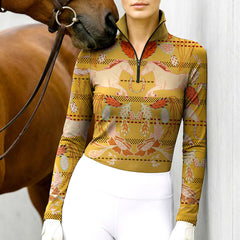 Woman wearing RIDER ATELIER Southwestern horse mustard yellow quarter-zip top with a chestnut horse