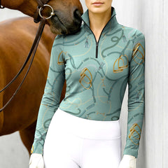 Woman wearing RIDER ATELIER tack quarter-zip top with a chestnut horse
