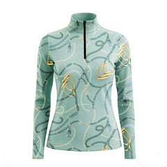 Woman wearing RIDER ATELIER tack quarter-zip top at the show jumping arena
