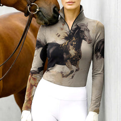 Woman wearing RIDER ATELIER watercolor galloping horse quarter-zip top with a chestnut horse