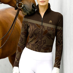 Woman wearing RIDER ATELIER western botanical horse brown quarter-zip top with a chestnut horse