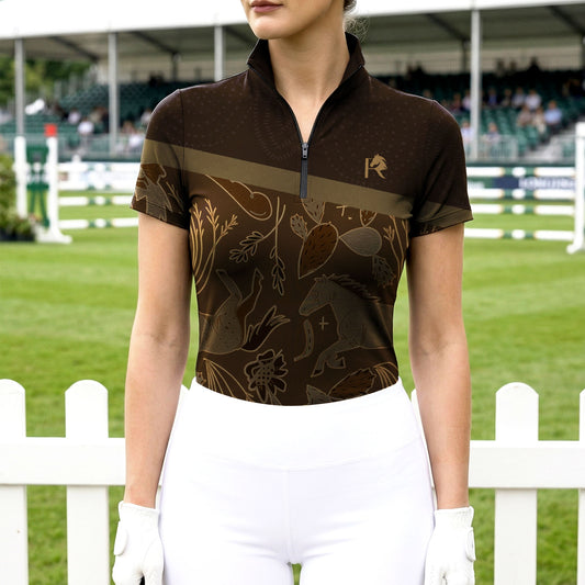Woman wearing RIDER ATELIER western short sleeve quarter-zip top at the show jumping arena
