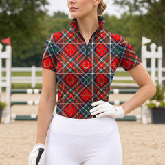 Model wearing preppy tartan riding top at outdoor equestrian jump competition arena