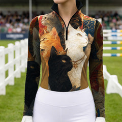 Model wearing fine-art cat themed riding apparel photographed at a spectator-filled outdoor equestrian show jumping venue
