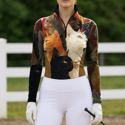 Full-body model portrait wearing vintage regal cat print riding apparel beside white pasture fencing while gripping a riding crop
