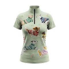 Full-body model shot wearing cozy cottage floral multi-breed dog short sleeve top at outdoor equestrian show jumping arena with spectator stands, holding riding crop
