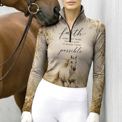 Model leaning against light grey stable wall beside chestnut horse wearing vintage faith running white horse daisy riding top
