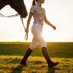 Sunset grass pasture side profile shot of model leading brown horse displaying painterly sunburst pale horse portrait riding top
