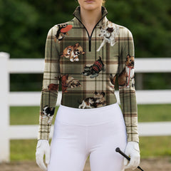 Soft natural light countryside grass wooden bench shot of model sitting beside real terrier dog wearing muted green cream tartan plaid multi-breed puppy print long sleeve riding top