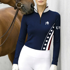 Model wearing the USA Patriotic Star Stripe Print Riding Top at the stable, with a chestnut horse
