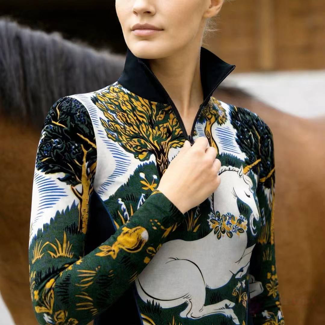 Model wearing enchanted forest print riding top adjusting zipper inside stable