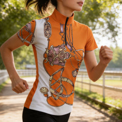 Outdoor lifestyle shot of female model running wearing orange‑white short‑sleeve quarter‑zip riding top with vintage equestrian bridle‑bit scarf print