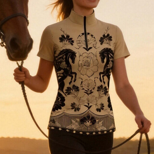 Warm golden sunset countryside horse farm shot of female rider holding horse lead rope wearing neutral beige symmetrical dual vintage stallion floral peony print short sleeve quarter-zip riding top