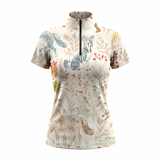 White background studio shot of cream vintage engraved horse dog floral print short sleeve quarter zip riding top