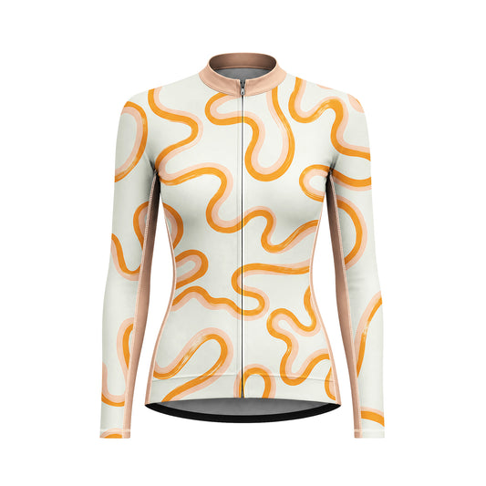Female model wearing cream orange wavy curve long sleeve bike jersey riding winding mountain road at golden hour, front partial torso view
