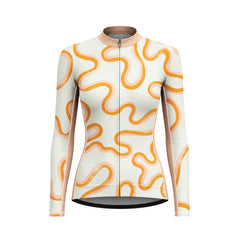 Female model wearing cream orange wavy curve long sleeve bike jersey riding winding mountain road at golden hour, front partial torso view
