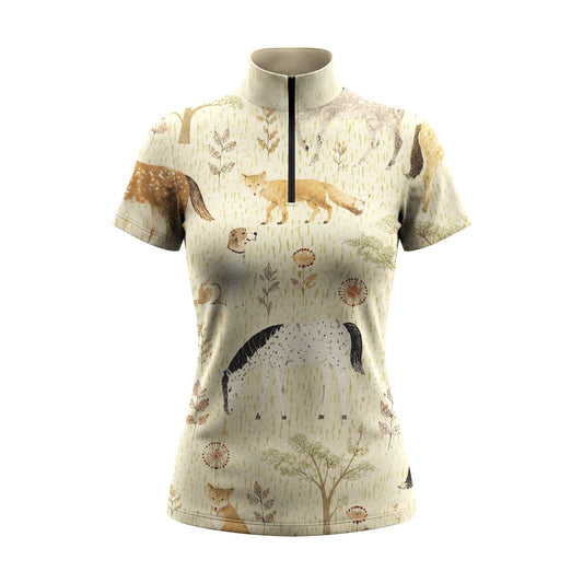 White background studio product shot of pale cream short sleeve quarter-zip riding top with scattered watercolor fox, horse and hound woodland ditsy print
