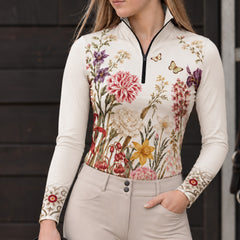 Close up front view of the riding top worn with beige breeches by a dark wooden barn wall