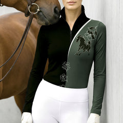 Close up of the black and dark green color block riding top showing the white diagonal split line, floral graphics and stitched sleeve cuffs