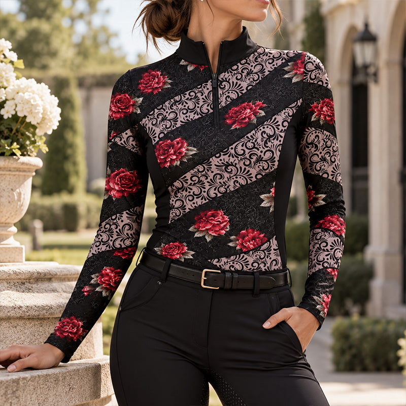 Rider in the floral riding top leaning on a stone balustrade near a stone stable building with flowering planters