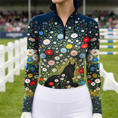 Model wearing the navy wildflower and foal print riding top with light breeches in an arena setting