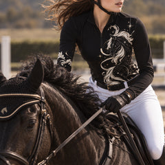 Rider wearing the top while mounted on a black horse in an outdoor arena