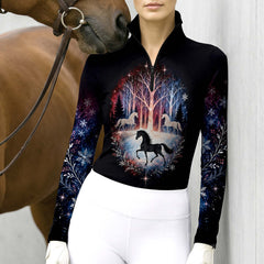Model wearing the riding top standing next to a horse