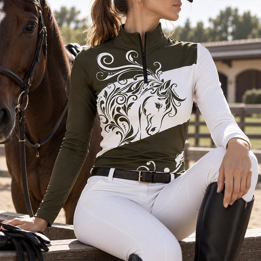 Rider wearing the brown horse print riding top seated on a wooden fence next to a brown horse at a stable