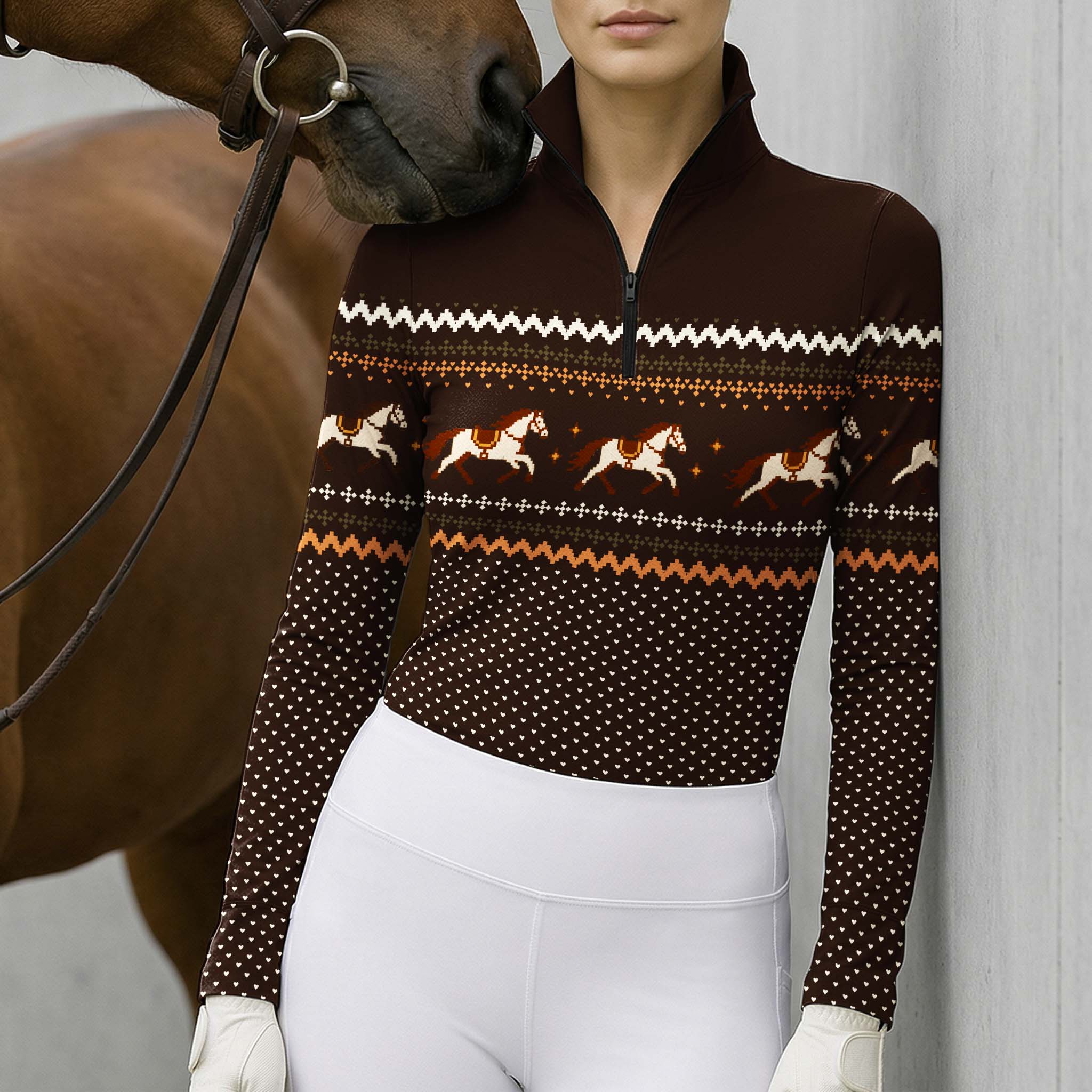Lifestyle view of the riding top worn by a rider standing beside a horse