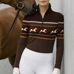 Lifestyle view of the riding top worn by a rider standing beside a horse