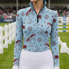 Woman wearing a light blue celestial horse print riding top with white breeches and white gloves