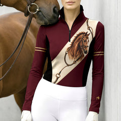 Close view of the stand up collar, black quarter zip and gold upper sleeve stripes on the burgundy riding top