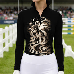 Woman wearing the black celestial horse print riding top with white breeches while standing near a brown horse with leather bridle