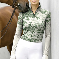 Model wearing the off white printed riding top standing next to a brown horse against a light gray wall