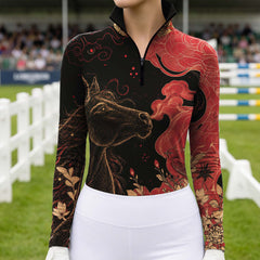 Black long sleeve riding top with gold horse head print shown in a show jumping arena