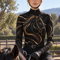 Black quarter zip riding top with gold horse line art worn while mounted with black riding gloves and a helmet