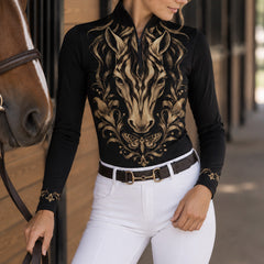 Close view of gold scroll style cuff print on black long sleeve quarter zip riding top
