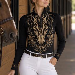 Close view of gold zebra striped horse and floral print on black long sleeve quarter zip riding top