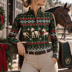 Woman leaning on a wooden barn fence wearing the festive printed riding top