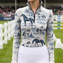 Rider wearing the blue print riding top while mounted on a brown horse
