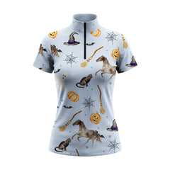 Studio white‑background product mockup of women’s pale‑blue short‑sleeve quarter‑zip riding top with full Halloween themed all‑over print