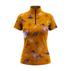 Studio white‑background product mockup of women’s burnt‑orange short‑sleeve quarter‑zip riding top with full Halloween themed all‑over print