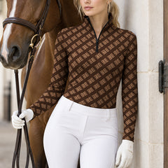 Dark brown monogram print riding top with stand collar and long sleeves worn with white riding gloves and leather reins