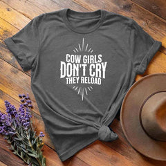 Dark gray "Cow Girls Don't Cry They Reload" western equestrian t-shirt, flat lay on wooden background