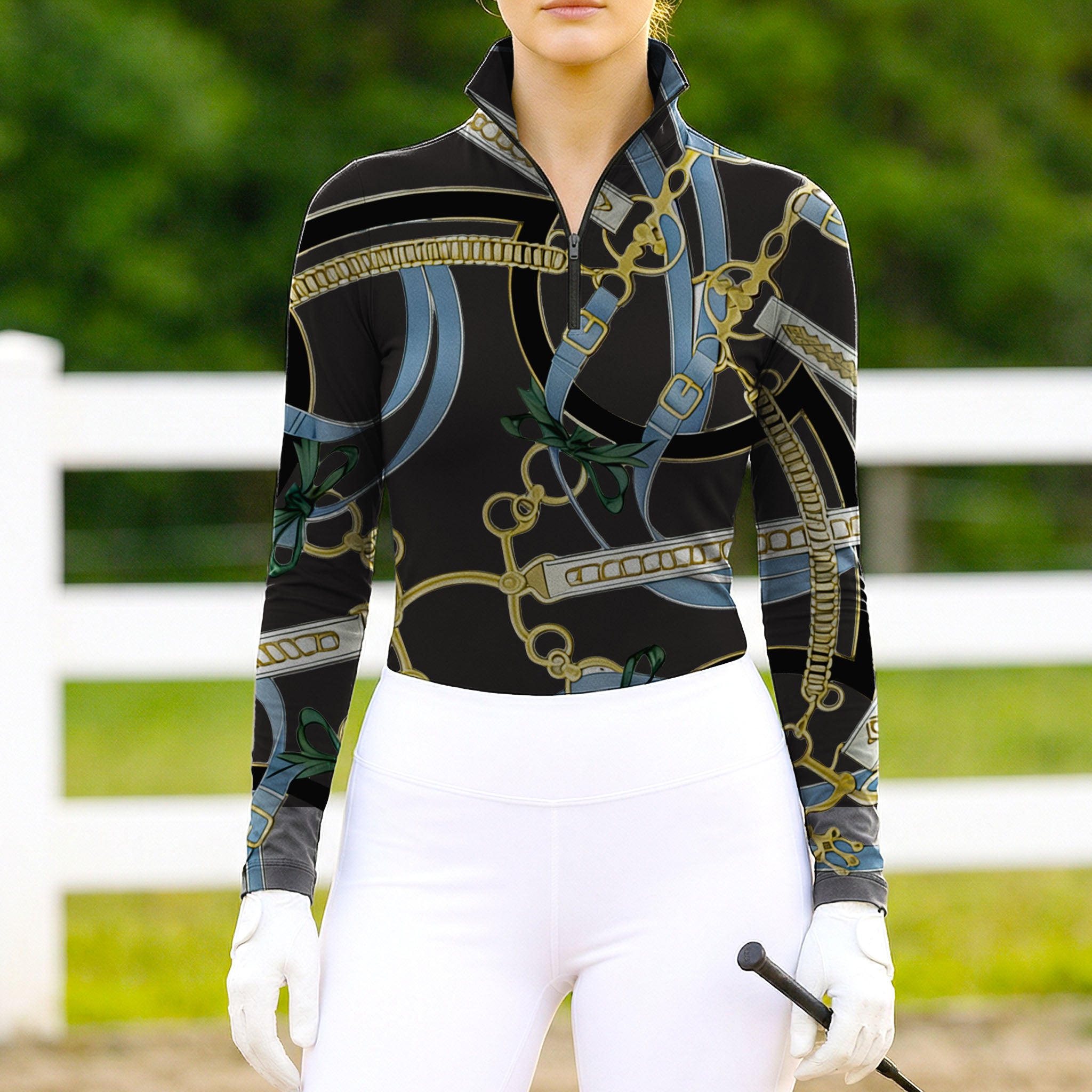 Woman wearing RIDER ATELIER equestrian belt & bow black gold quarter-zip top at the outdoor pasture