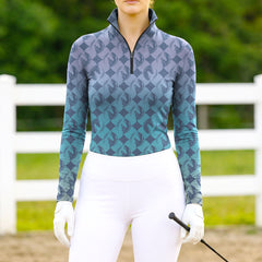 Woman wearing RIDER ATELIER gradient diamond horse head teal-purple equestrian quarter-zip top at the outdoor pasture