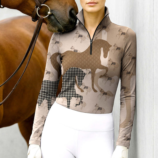 Woman wearing RIDER ATELIER heritage houndstooth horse taupe equestrian quarter-zip top at the barn with a chestnut horse
